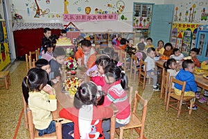 CANTON, CHINA Ã¢â¬â CIRCA MARCH 2019: Kids in kindergarten calebrate a birthday. Birthday party in kindergarten.